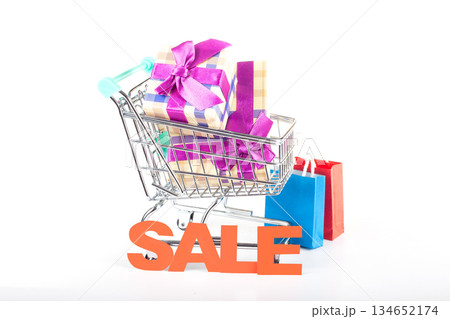 Holiday shopping cart filled with gift boxes and sale packages Holiday shopping cart filled with gift boxes and sale packages 134652174