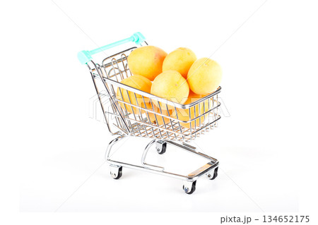 Shopping cart filled with ripe apricots 134652175