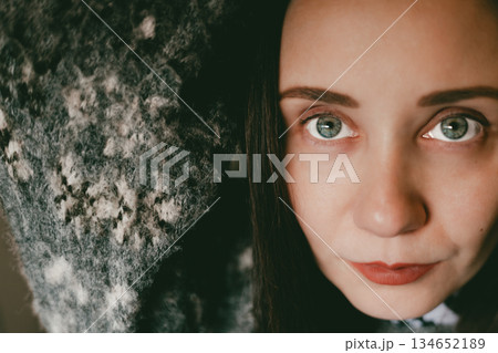 Close-up portrait of a young woman with natural makeup, soft lighting, warm tones. Focus on blue eyes and skin texture, red lips and sexy smile. Close-up portrait of a young woman with natural makeup, soft lighting, warm tones. Focus on blue eyes and skin texture, red lips and sexy smile. 134652189