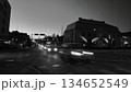 Porvoo, Finland - December 08, 2020: Nighttime city street scene features blurred car lights, showcasing urban life and movement in a bustling environment with buildings 134652549