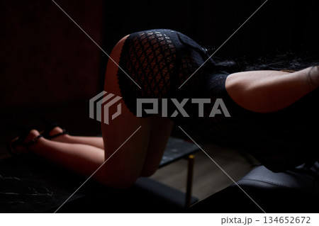 Sensual studio photograph highlighting elegant lingerie and confident posture, Artistic portrayal of provocative fashion in softly lit setting emphasizing charm and allure Sensual studio photograph highlighting elegant lingerie and confident posture, Artistic portrayal of provocative fashion in softly lit setting emphasizing charm and allure 134652672