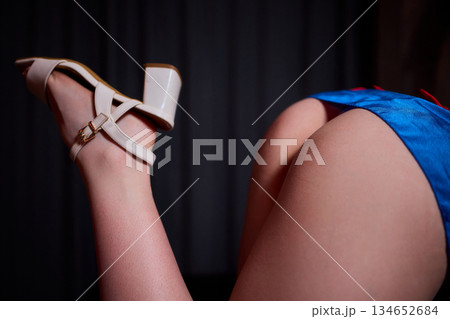Sensual studio photograph highlighting elegant lingerie and confident posture, Artistic portrayal of provocative fashion in softly lit setting emphasizing charm and allure 134652684