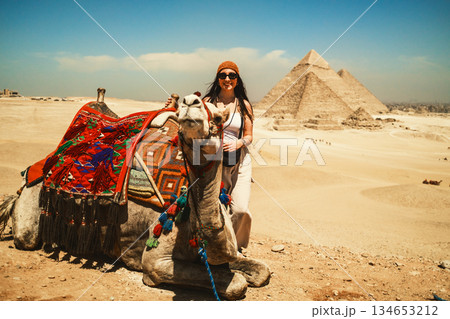 Woman And Traditional Camel At The Pyramids 134653212