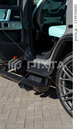 Luxury SUV parked with open door showcasing stylish interior and sleek design features 134656600