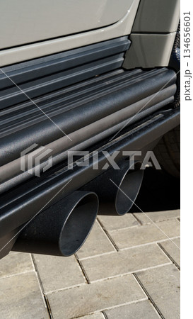 Chrome exhaust pipes gleaming under sunlight at a car show in the afternoon Chrome exhaust pipes gleaming under sunlight at a car show in the afternoon 134656601