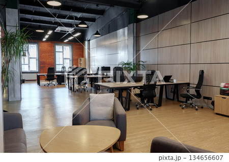 Modern office space with wooden accents and comfortable furniture in a bright environment 134656607