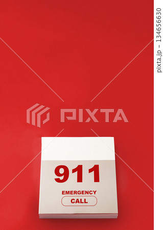 Emergency call calendar marked with 911 on bright red background Emergency call calendar marked with 911 on bright red background 134656630