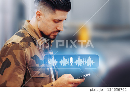 Man uses smartphone to send voice message in urban area Man uses smartphone to send voice message in urban area 134656762