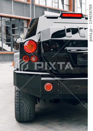 Detailed view of a modern black SUV parked in an urban setting with a stylish design 134656769