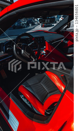 Luxurious red sports car interior with sleek design and inviting features Luxurious red sports car interior with sleek design and inviting features 134656801