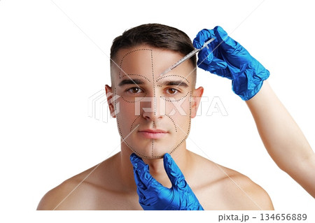 Man receives cosmetic treatment for facial enhancement with a syringe in a clinical setting Man receives cosmetic treatment for facial enhancement with a syringe in a clinical setting 134656889