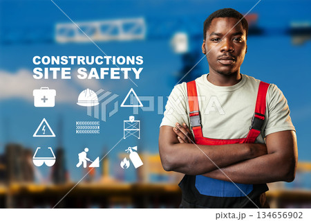 Construction worker promotes site safety with clear safety symbols and guidelines 134656902