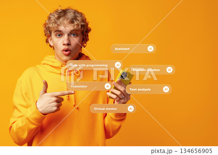 Young person gestures while holding a phone with AI-related tools displayed on screen 134656905