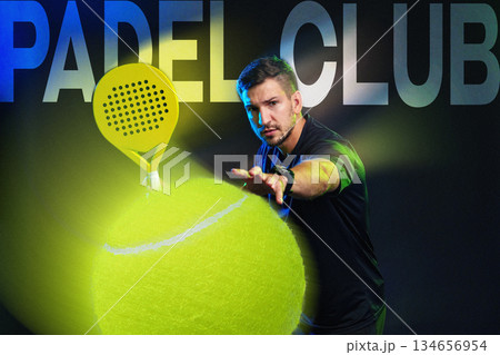 Male player practicing padel sport with fluorescent ball in indoor court setting Male player practicing padel sport with fluorescent ball in indoor court setting 134656954