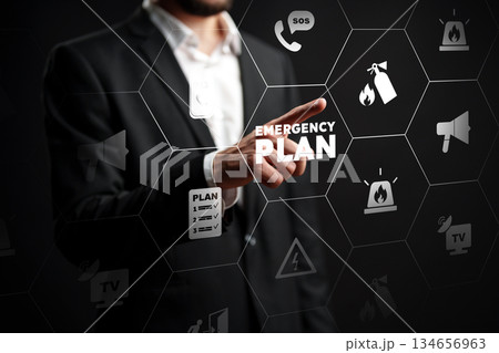 Businessperson interacts with emergency plan icons in a digital setting at a workplace Businessperson interacts with emergency plan icons in a digital setting at a workplace 134656963