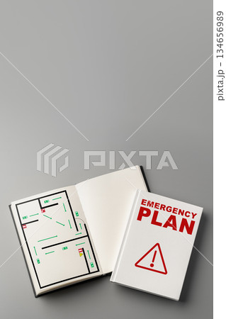 Emergency plan booklet with a maze layout and blank pages displayed on a gray surface 134656989