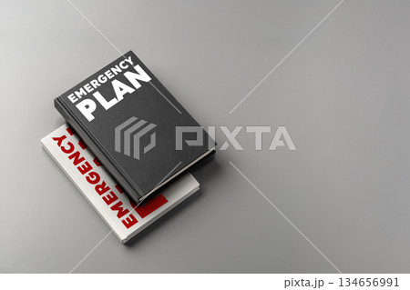 Emergency plan book placed on gray surface with another plan beneath it 134656991