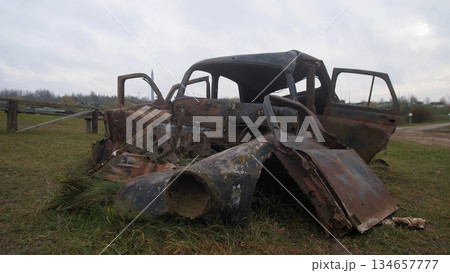 decaying car on rough terrain, dilapidated automobile with shredded interior rests on rugged trail, neglected rusted vehicle with torn inside lies abandoned on unsteady and bumpy road decaying car on rough terrain, dilapidated automobile with shredded interior rests on rugged trail, neglected rusted vehicle with torn inside lies abandoned on unsteady and bumpy road 134657777
