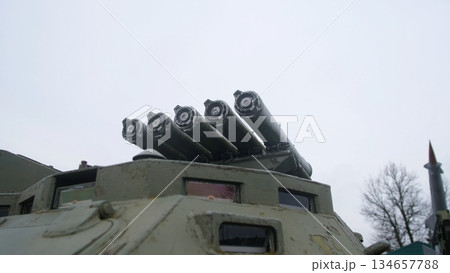 four-tube rocket launcher mounted on armored turret roof, angled upward against cloudy sky, armored hatch and tube cluster convey rugged ordnance readiness and museum display vibe. four-tube rocket launcher mounted on armored turret roof, angled upward against cloudy sky, armored hatch and tube cluster convey rugged ordnance readiness and museum display vibe. 134657788