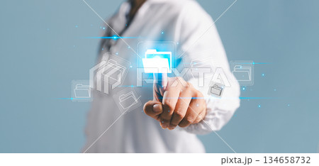 A business professional touching a digital folder icon, representing data management, cloud storage, information security and modern technology solutions for efficient file organization. A business professional touching a digital folder icon, representing data management, cloud storage, information security and modern technology solutions for efficient file organization. 134658732