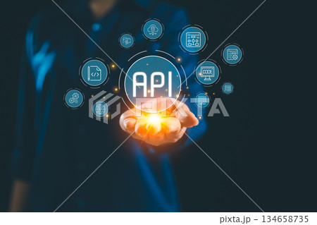 Glowing API interface floating above hand connected digital icon representing application programming interface system integration backend services cloud technology scalable modern software solutions Glowing API interface floating above hand connected digital icon representing application programming interface system integration backend services cloud technology scalable modern software solutions 134658735