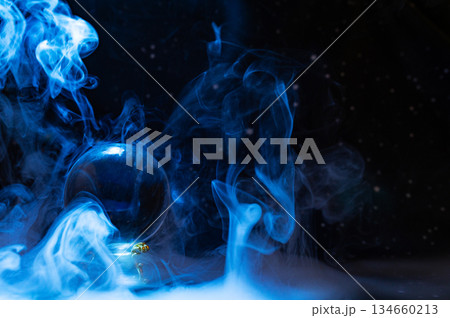Crystal magical glass ball, mystical smoke and abstract light painting on dark background. Forecasting AI intuition, data flow, future technology. Crystal magical glass ball, mystical smoke and abstract light painting on dark background. Forecasting AI intuition, data flow, future technology. 134660213