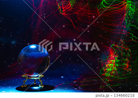 Crystal magical glass ball, mystical smoke and abstract light painting on dark background. Forecasting AI intuition, data flow, future technology. 134660218