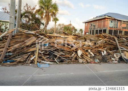 Street-side heaps of storm debris and trash left behind by Hurricane Milton on Manasota Key in Englewood, Florida. Severe damage to homes from storm surge. Harsh aftermath of the natural disaster Street-side heaps of storm debris and trash left behind by Hurricane Milton on Manasota Key in Englewood, Florida. Severe damage to homes from storm surge. Harsh aftermath of the natural disaster 134661315
