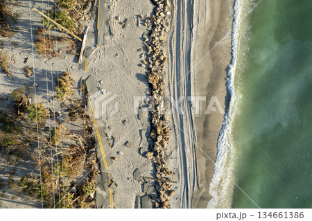 Road erosion after hurricane in Florida. Storm surge washed away asphalt on Manasota Key road at Blind Pass Beach. Severe damage to waterfront infrastructure 134661386