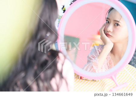 鏡の前でポーズをする若くてかわいいアジアの女性の美容ポートレート 鏡の前でポーズをする若くてかわいいアジアの女性の美容ポートレート 134661649