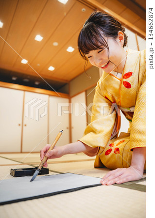 和室で習字をする若い着物姿の女性 134662874
