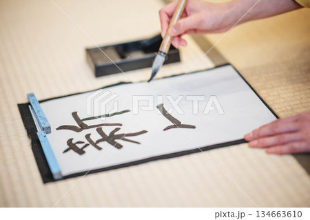 着物で習字をしている手元 134663610