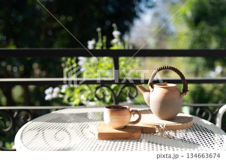 earthenware Tea set on balcony outdoor in winter under strong sunlight 134663674