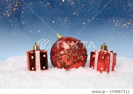 Christmas tree baubles on blue background with white snow and golden lights. Festive winter holiday background. Design with copy space for greeting card, text, advertising, banner, invitation 134667312