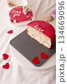 Romantic cake with red frosting and heart decorations on slate plate 134669096