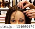 Wig fitting process in retail store displaying human hair wigs for fashion and styling concepts 134669479