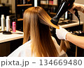 Professional hair styling and blow drying at a modern salon 134669480
