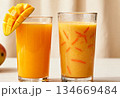 Fresh mango juice and smoothie with fruit garnish for a refreshing tropical drink experience 134669484