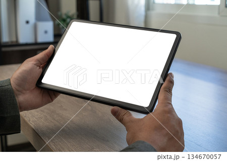 Pad digital tablet with blank screen man holding tablet mockup image of a business replaces your design mockup 134670057