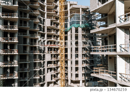Construction of a building. Construction site with crane. Business, development, industry. 134670259