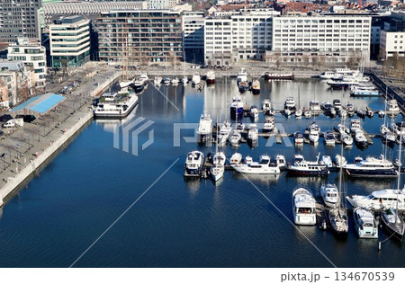 Antwerp city waterfront marina aerial view, boats moored along the docks, historic architecture in background. High quality photo 134670539