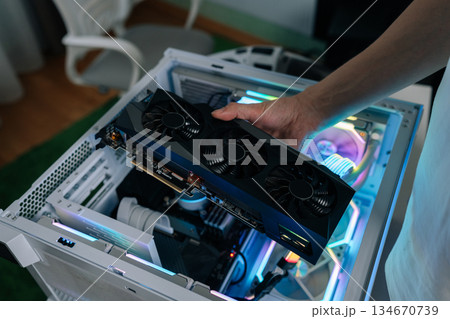 Hands of computer technician using screwdriver to assemble and service internal components of desktop pc, performing maintenance and upgrade tasks on hardware. Concept of desktop PC service. 134670739