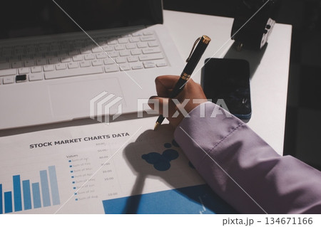 Above table with finance papers, graphs and big data during teamwork meeting with accounting or marketing team discussing budget, strategy or growth development. Closeup of SEO team doing research 134671166
