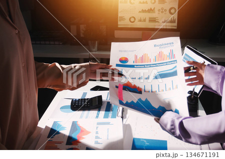 Above table with finance papers, graphs and big data during teamwork meeting with accounting or marketing team discussing budget, strategy or growth development. Closeup of SEO team doing research 134671191