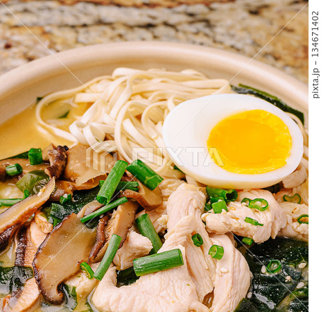 Tasty chicken noodle soup with egg and veggies at a restaurant Tasty chicken noodle soup with egg and veggies at a restaurant 134671402