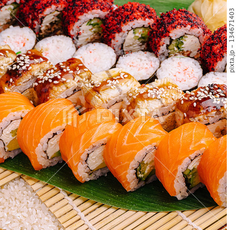 Delicious sushi rolls displayed on a bamboo mat with vibrant colors 134671403