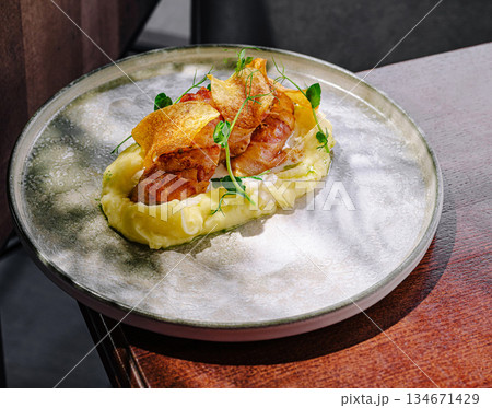 Delicious dish showcased on a plate with creamy mashed potatoes and garnish Delicious dish showcased on a plate with creamy mashed potatoes and garnish 134671429