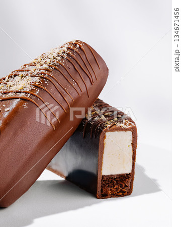 Creamy chocolate-coated dessert on a white background Creamy chocolate-coated dessert on a white background 134671456
