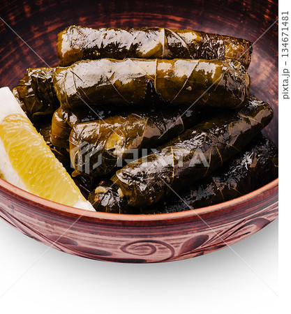 Delicious homemade stuffed grape leaves served in a traditional bowl 134671481