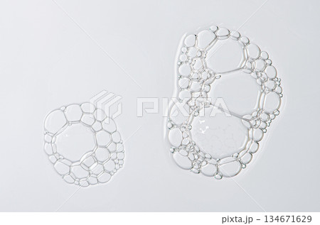 Sample of the foam of shower gel or soap suds or shaving foam. Cosmetic skin care product. Macrophotography. 134671629